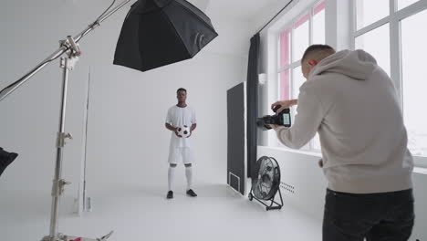 professional-photosession-of-afro-american-footballer-photographer-is-taking-picture-of-champion